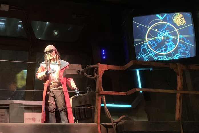 Animatronic character Hondo Ohnaka explains to guests what kind of mission they will soon be on.